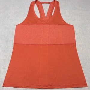 Lululemon Pedal To The Metal Singlet.Orange,ribbed,front chest panelling.Size 6